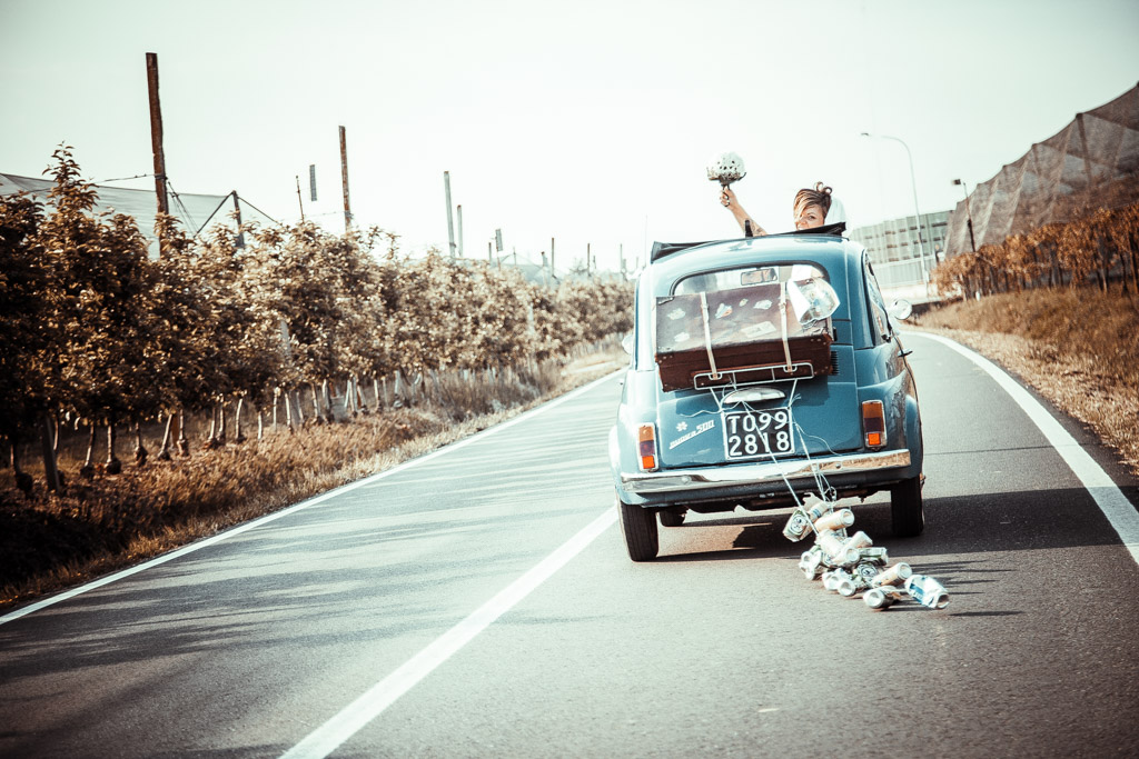 sposi dopo il matrimonio vanno al ristorante corte poli a san martino buonalbergo mentre la sposa esce con la testa dalla cappotta della cinquecento d'epoca blu